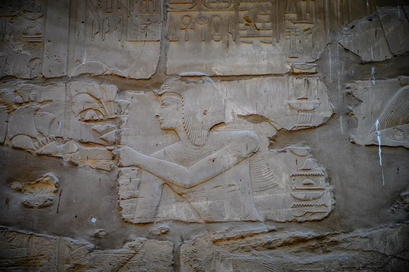 A close up of a stone wall with carvings on it